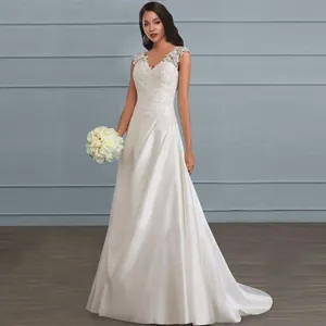 Elegant floor-length white wedding dress with lace patchwork and V-neckline