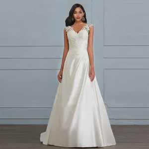 Elegant V-neck white wedding dress featuring lace stitching and a flowing A-line satin skirt