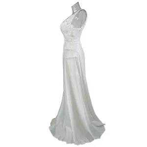 Side view of elegant white lace patchwork wedding dress with satin skirt and hollow back.