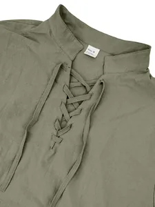 Detail of olive green men's linen shirt with lace-up V-neck and mandarin collar.