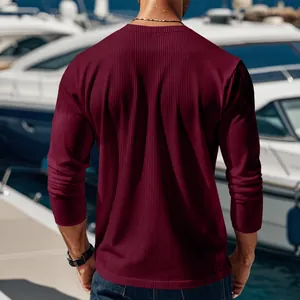 Back view of men's burgundy ribbed knit long sleeve shirt in luxury yacht setting