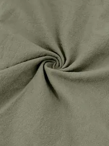 Macro detail of olive green breathable cotton linen fabric texture for men's Henley shirt