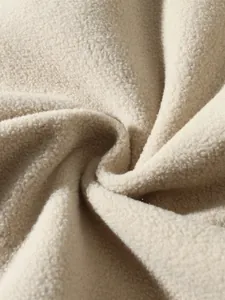 Macro detail view showing the soft beige fleece fabric texture