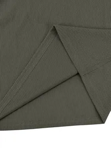 Detailed close-up of dark olive ribbed corduroy fabric showing fine vertical texture