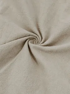 Macro detail of breathable beige cotton linen fabric showing natural texture and weave