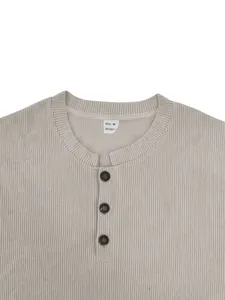 Macro view showing the textured corduroy fabric and henley neck details on a gray shirt