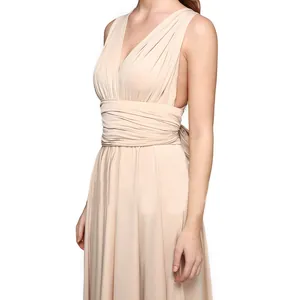 Close-up detail of a beige multi-way wrap infinity dress with elegant pleated waist.