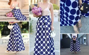 Detailed view of the retro blue and white polka dot high-waisted A-line maxi skirt.