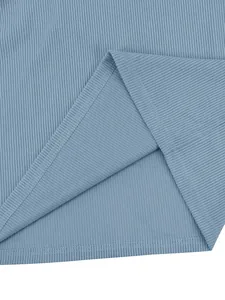 Close-up of blue ribbed fabric texture and hem stitching on men's sweatshirt
