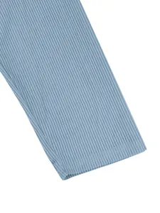 Close-up detail of the ribbed cuff on a men's blue long-sleeve casual top