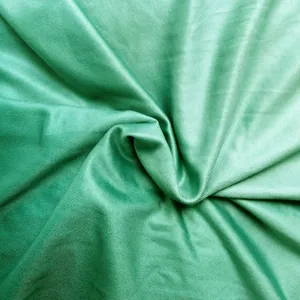 Close-up macro detail of green ribbed fabric with a luxurious satin sheen for long evening gowns
