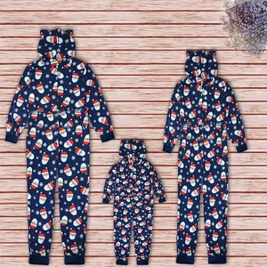 Family matching Christmas Santa Claus print hooded onesies laid out on a light wood background