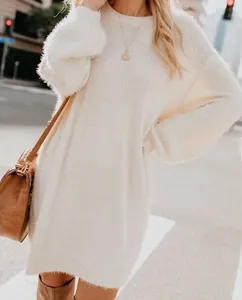 Close-up detail of cream white long-sleeved fuzzy sweater dress with soft plush texture