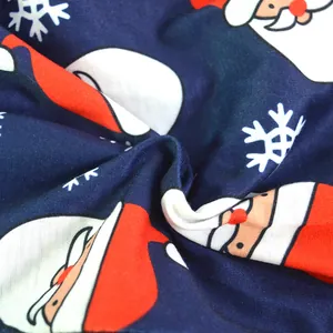 Close-up of soft navy blue fabric with Santa Claus and snowflake prints for homewear
