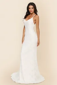 Elegant white lace wedding dress with V-neck and delicate spaghetti straps detail view