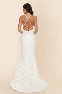 Back view of elegant white lace mermaid wedding dress with criss-cross straps and train