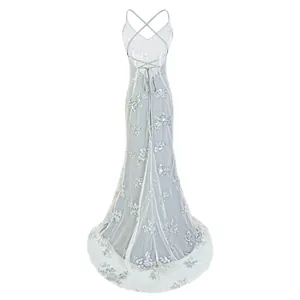 Detailed back view of an elegant silver sequined mesh gown featuring a sexy cross backless design