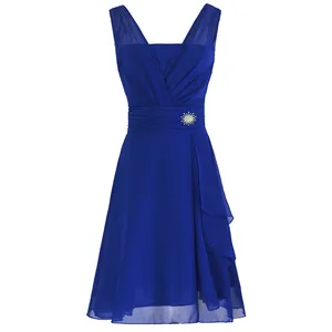 Detailed view of a royal blue chiffon bridesmaid cocktail dress with sunburst brooch