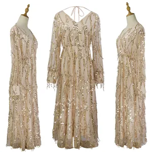Triple view of champagne long-sleeved maxi dress with gold sequins and fringe