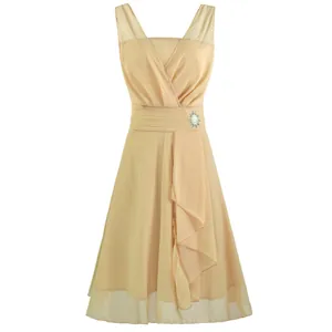 Elegant champagne chiffon cocktail dress with V-neckline and sparkling rhinestone brooch.