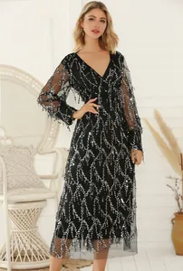 Detail of a black V-neck sequin dress with fringe embellishments for parties