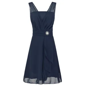 Front view of elegant navy blue chiffon bridesmaid dress with pleated waist and brooch.
