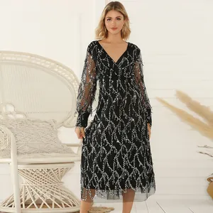 Elegant black V-neck cocktail dress with sparkling silver sequins and mesh sleeves details