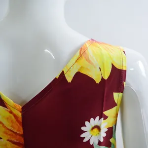 Detail view of the V-neckline and vibrant sunflower print on a sleeveless summer dress