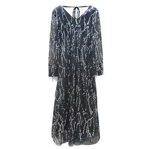 Close-up detail showing the silver wavy sequin patterns on a black V-neck dress