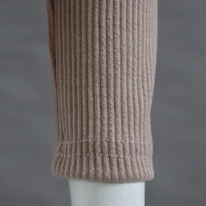 Detailed macro view showing the fine ribbed knit texture and durable hem stitching of the beige sweater
