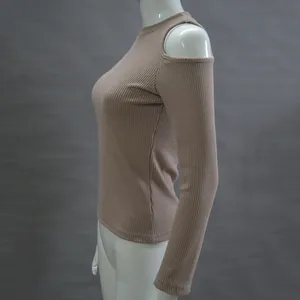 Detail view of women's ribbed knit top featuring a cold-shoulder cutout and mock neck