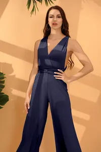Full body shot of a navy blue multi-way jumpsuit featuring a wrap waist and wide legs