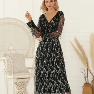 Elegant black V-neck maxi dress with shimmering silver sequins and tassel details