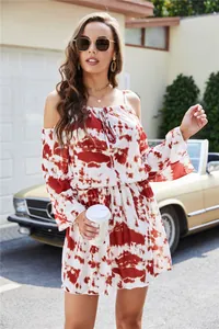 Detailed view of red and white tie-dye off-shoulder mini dress for summer vacation wear.