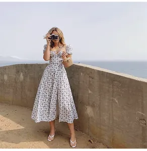 Summer floral puff sleeve maxi dress with tie-front and high slit in coastal setting