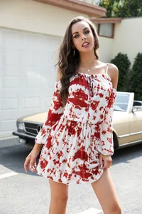 Close-up detail of a red tie-dye print off-the-shoulder dress for summer vacation styling