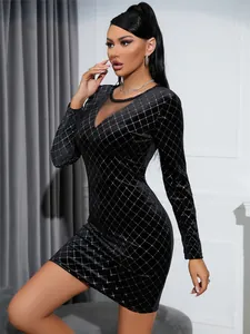 Detailed view of the mesh patchwork and rhinestone grid pattern on black velvet dress