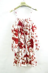 Detail view of a vibrant red and white tie-dye cold-shoulder sundress with elastic waist