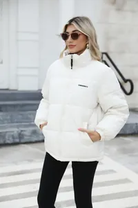 Stylish white puffer jacket for women with warm quilted design and high collar