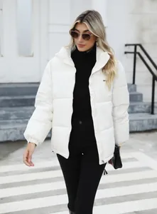 Fashionable white women's puffer jacket styled with a black turtleneck and stylish sunglasses