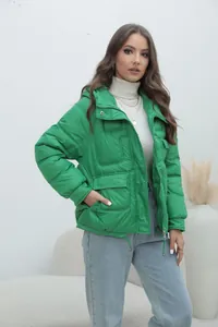 Professional shot of a stylish women's bright green padded winter jacket with a stand collar