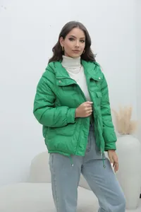 Stylish bright green women's thick quilted puffer jacket for winter outdoor fashion