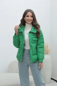 Detail view of a bright green stand-collar puffer jacket for women winter wear