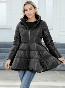 Close-up detail of a women's black puffer coat with elegant flared peplum waist design