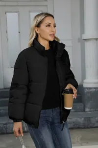 Women's black quilted puffer jacket shown in a lifestyle outdoor setting