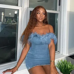 Detailed view of the feather trim on this sexy blue denim off-shoulder mini dress