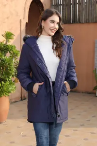 Detailed view of women's navy blue mid-length hooded winter parka with faux fur trim hood
