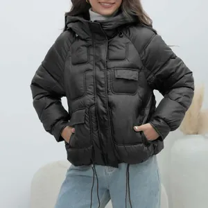 Full front view of a stylish thick black hooded puffer jacket with decorative pocket details