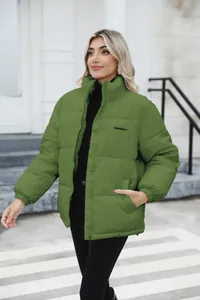 Detailed view of women's olive green puffer jacket with zip closure and standing collar