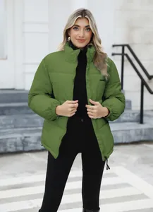 Detail view of a green plus-size winter puffer jacket with high collar and front zipper.